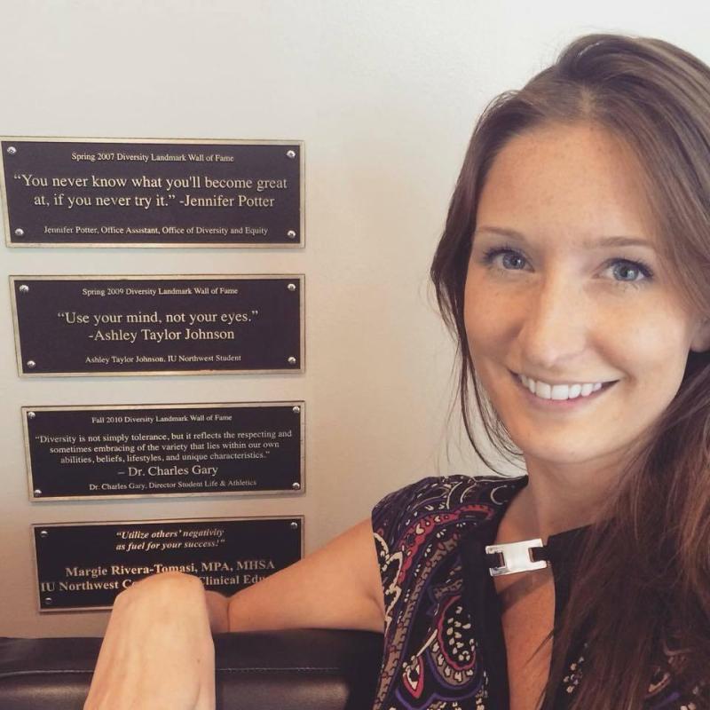 AJ T. Cole in front of her Diversity Landmark Award Plaque at Indiana University Northwest